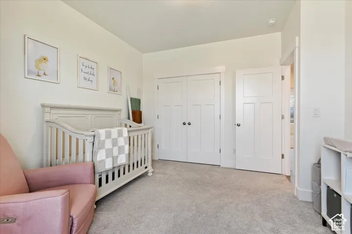 Neutral-toned wall-to-wall carpeting, white shaker-style interior doors, double-door closet with custom trim, and crisp white door casings