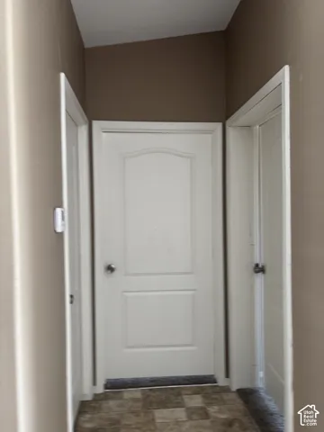 Three white interior doors with arched-top panels and brushed nickel hardware, complemented by tiled flooring