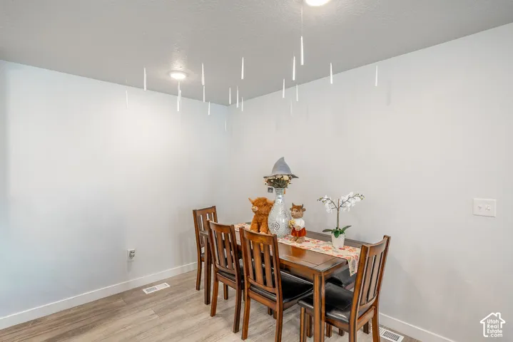 Neutral-toned walls paired with wood-finish flooring and recessed ceiling lighting