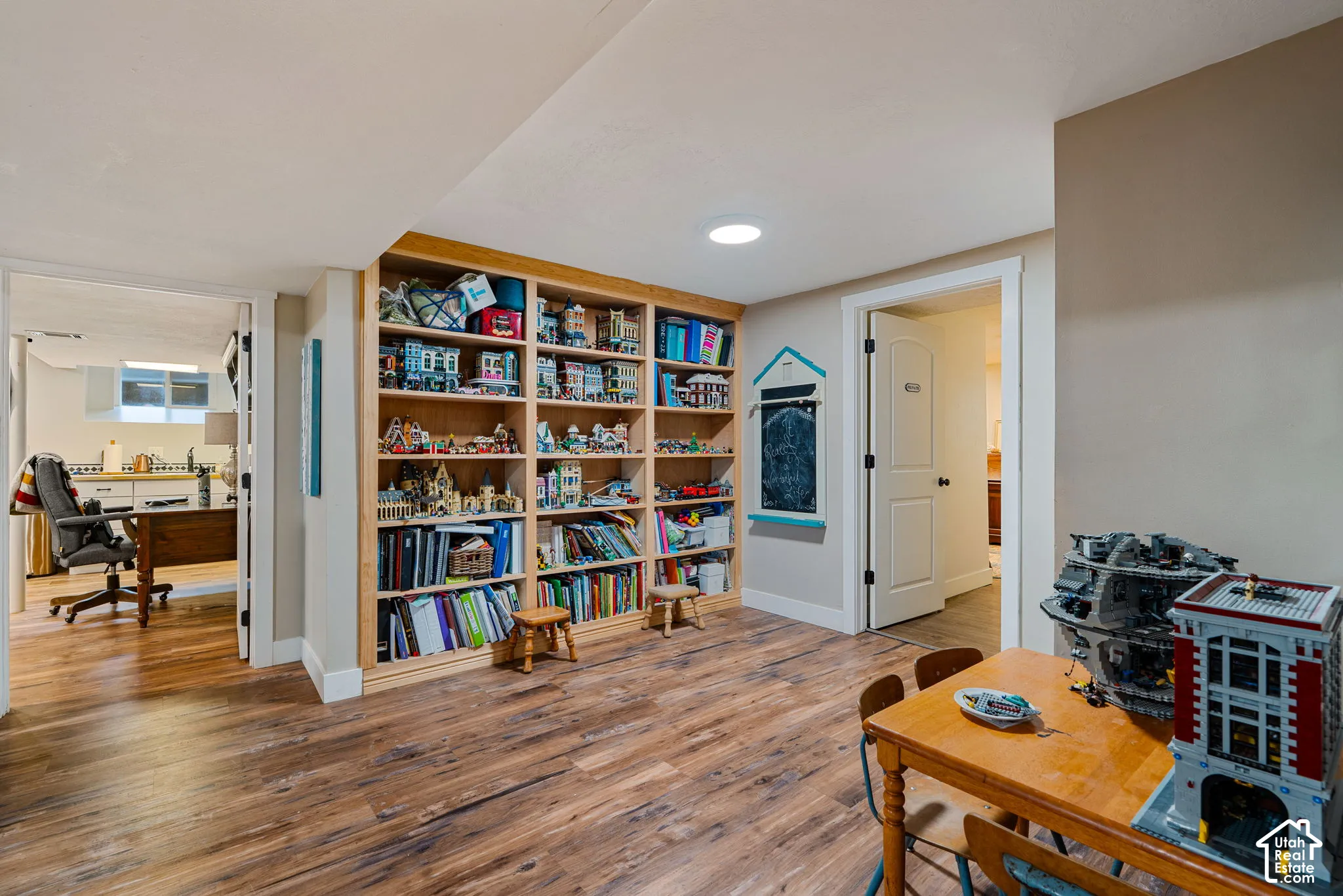 Built-in wood shelving, wood-finish flooring, and multi-panel interior doors
