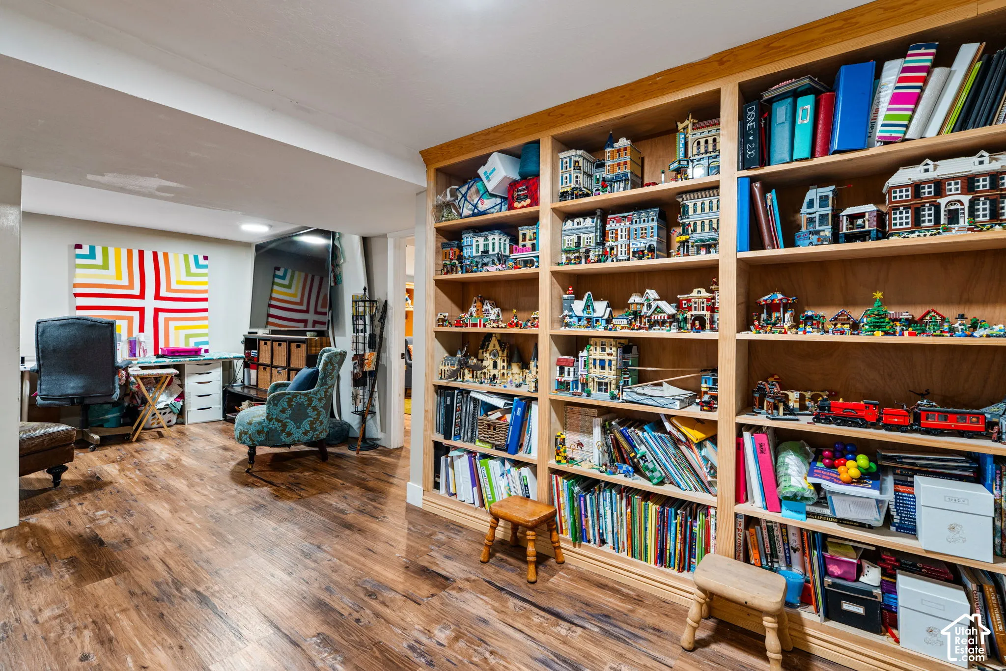Custom floor-to-ceiling built-in wood shelving featuring multiple fixed partitions and wood-finish flooring