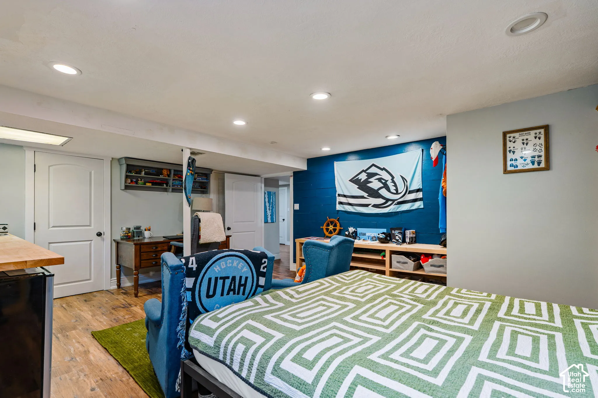 Interior space featuring wood-finish flooring, recessed lighting, and built-in shelving