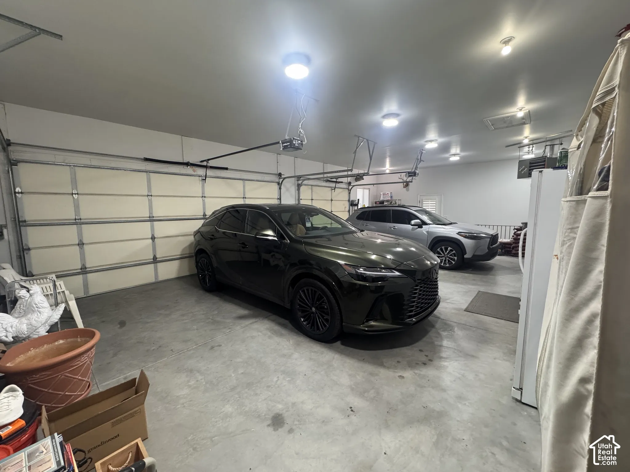 Spacious multi-car garage featuring finished walls, concrete flooring, and recessed ceiling lighting