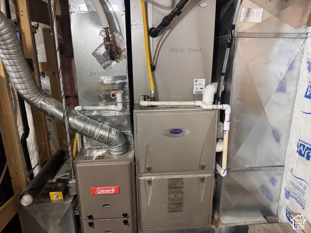 Multi-zone forced-air heating system featuring dual furnaces and integrated metal ductwork