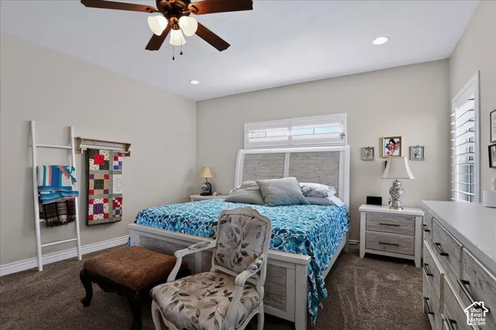 Neutral wall tones, recessed lighting, ceiling fan with light fixture, and windows featuring plantation shutters