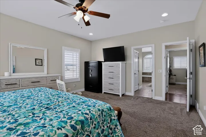 Neutral-toned room featuring recessed lighting, a ceiling fan with integrated light fixture, and plantation shutters