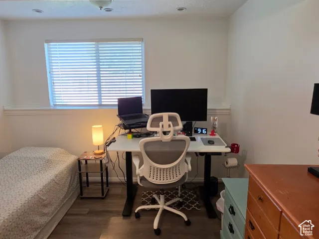 Recessed lighting, wood-finish flooring, and a single window with blinds