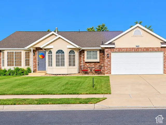 Brick and stucco exterior with multiple window styles