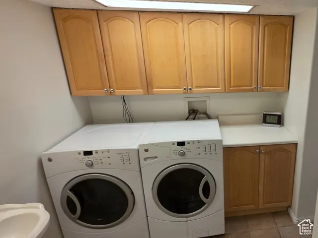 Built-in cabinetry with wood-finish doors, solid surface countertop, and tile flooring