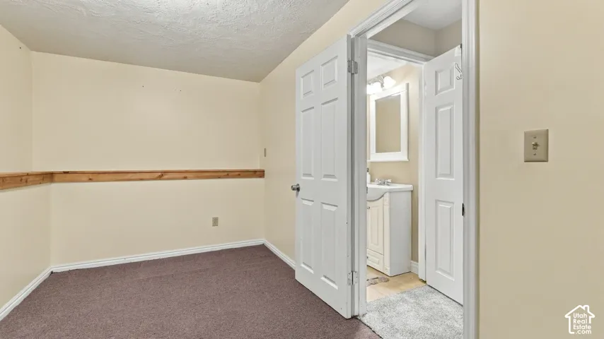 Interior space featuring wall-mounted wooden chair rail, neutral wall paint, and double-door entry