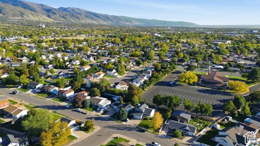 Aerial perspective featuring expansive mountain range backdrop and mature tree-lined streets