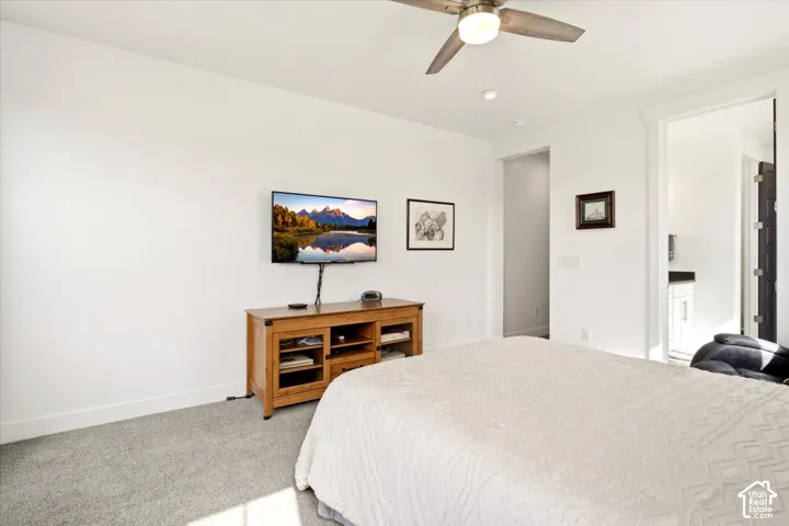 Bedroom featuring neutral-toned carpeting, recessed ceiling lighting, and a multi-blade ceiling fan with an integrated light fixture