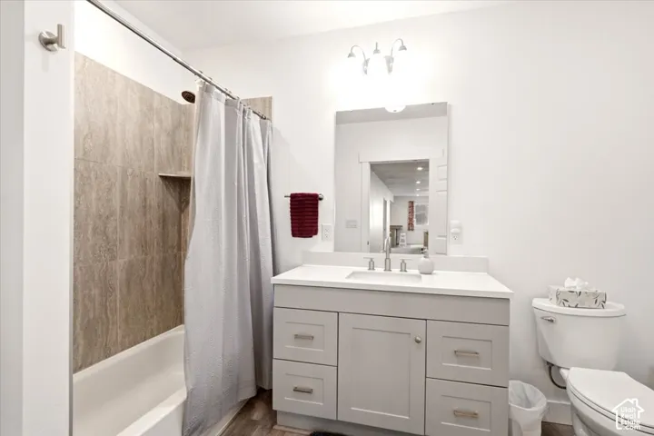 Contemporary bathroom featuring a dual-sink vanity with ample storage, white quartz countertop, and polished chrome fixtures