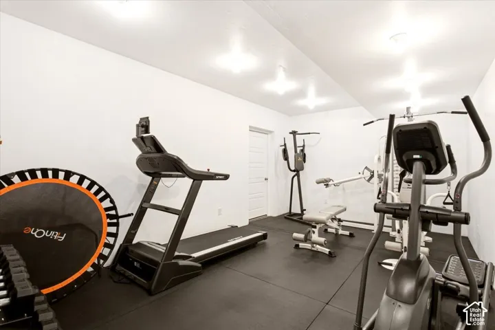 Dedicated room featuring durable rubberized flooring, crisp white walls, and multiple recessed ceiling lights