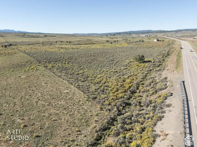 Expansive undeveloped acreage featuring native high-desert vegetation, gentle topography, and mountain horizon backdrops