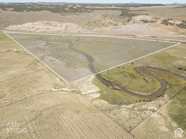 Expansive acreage featuring natural topography, a winding creek, and open pasture land