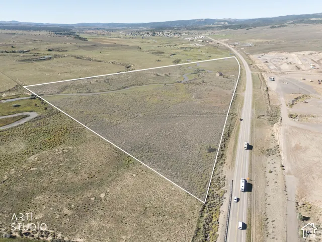 Expansive acreage featuring natural topography, open terrain, and road frontage