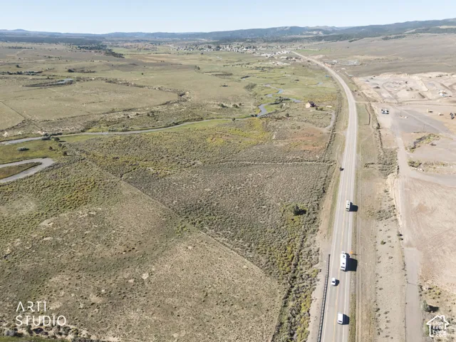 Expansive acreage featuring native high-desert vegetation, natural drainage channels, open topography, and prominent mountain horizon