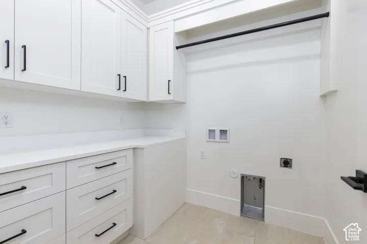 White shaker-style cabinetry with matte black hardware, integrated solid-surface countertop, and overhead hanging rod