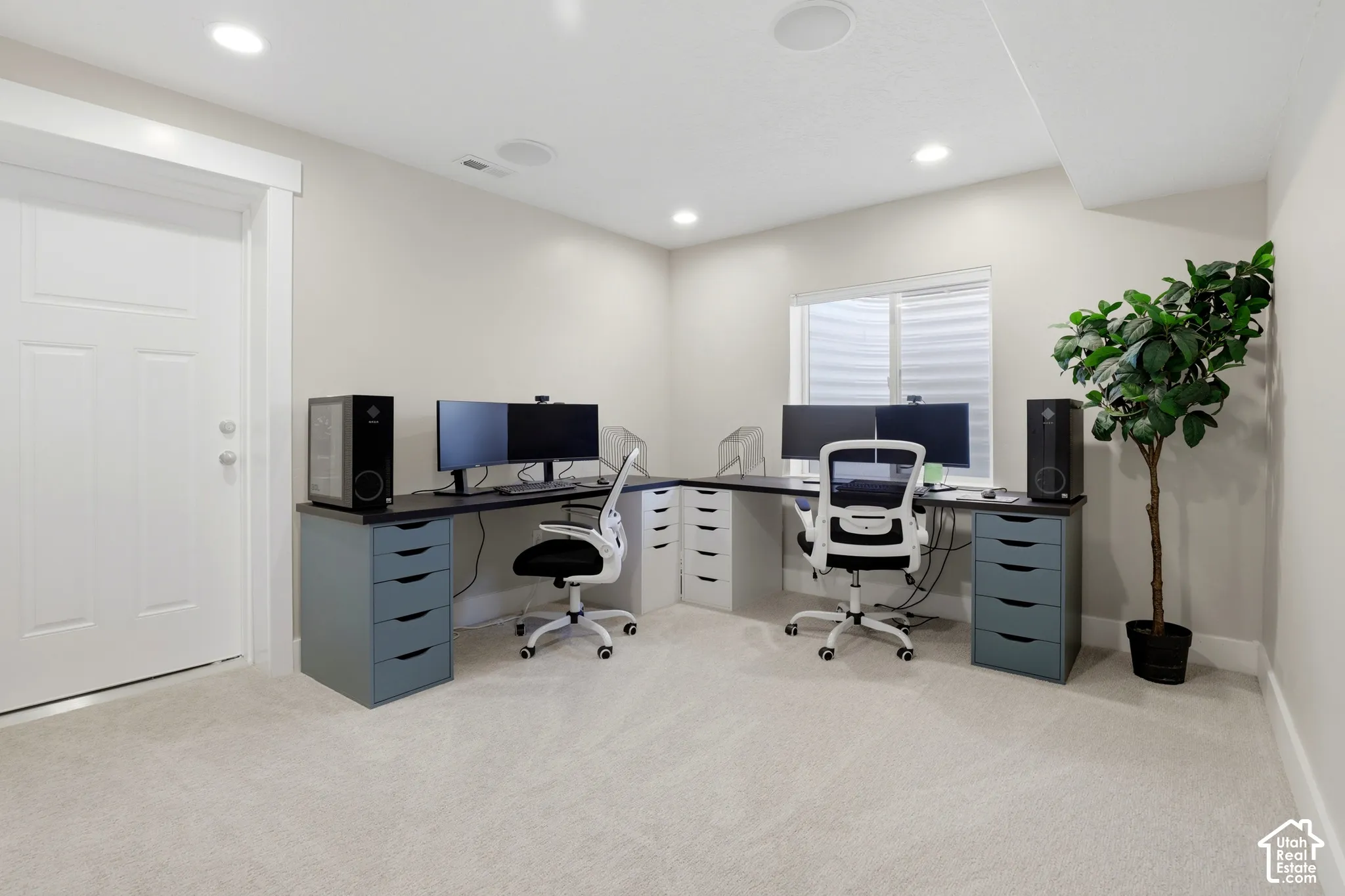 Room featuring neutral carpeting, recessed lighting, a single-panel interior door, and a built-in recessed window with horizontal blinds