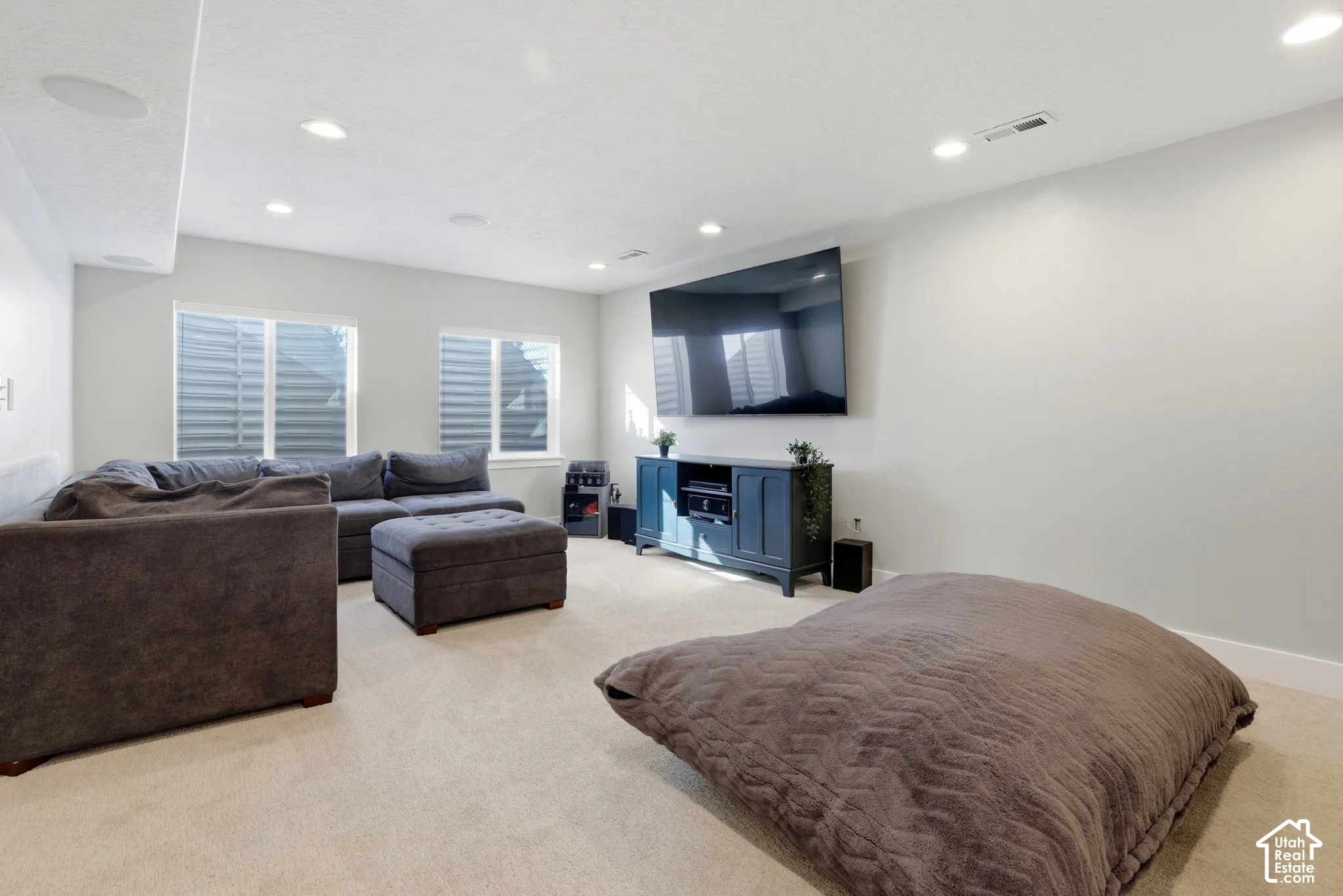 Spacious interior featuring recessed lighting, neutral wall tones, plush wall-to-wall carpeting, and dual windows