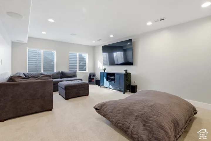 Spacious interior featuring recessed lighting, neutral wall tones, plush wall-to-wall carpeting, and dual windows