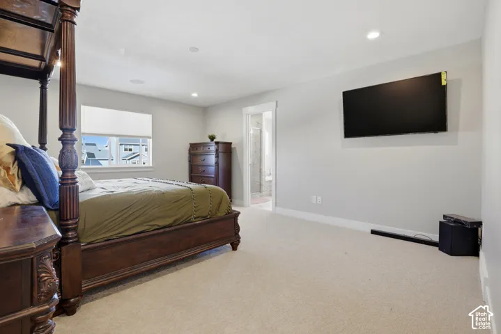 Neutral-toned walls, recessed lighting, wall-to-wall carpeting, and a double-hung window