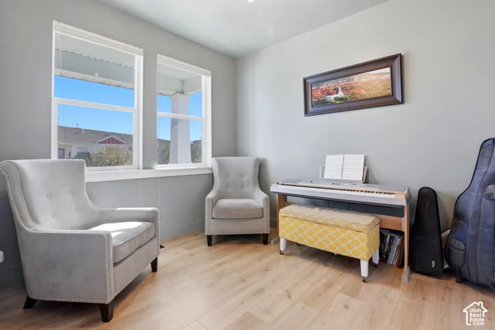 Neutral-toned interior room featuring wood-finish flooring and dual double-pane windows