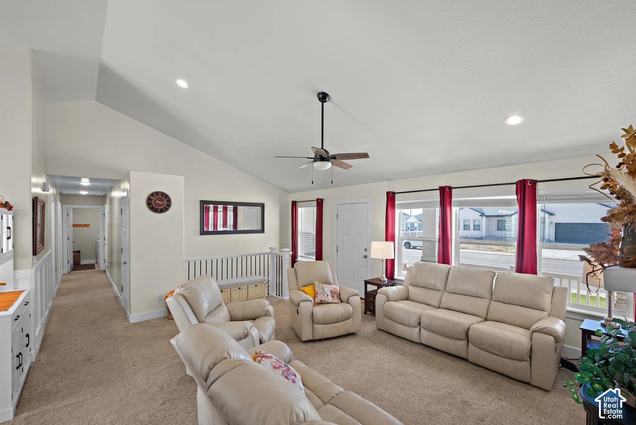 Vaulted ceilings, recessed lighting, ceiling fan, carpeted flooring, and white spindle railing