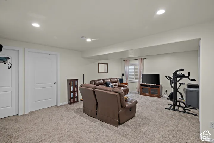 Neutral interior space featuring recessed ceiling lighting, wall-to-wall carpeting, and two-panel arch-top interior doors