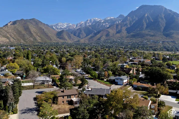 Aerial perspective featuring expansive mountain topography and established neighborhood tree canopy