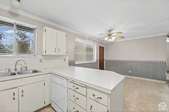 Kitchen featuring white cabinetry, solid-surface countertops, dual-basin stainless steel sink, integrated dishwasher, and tile flooring
