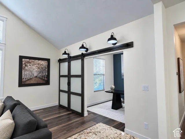 Vaulted ceilings, sliding barn doors with frosted glass inserts, and matte black industrial-style wall sconces