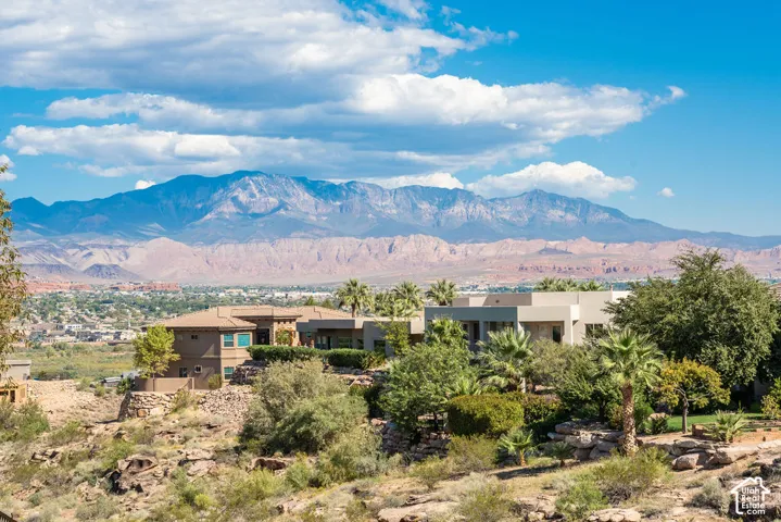 Modern architectural residence set on expansive desert grounds with mature landscaping and native vegetation
