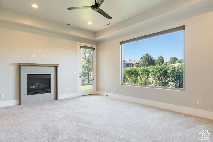 Fireplace with tile surround, wood-finish mantel, and hearth