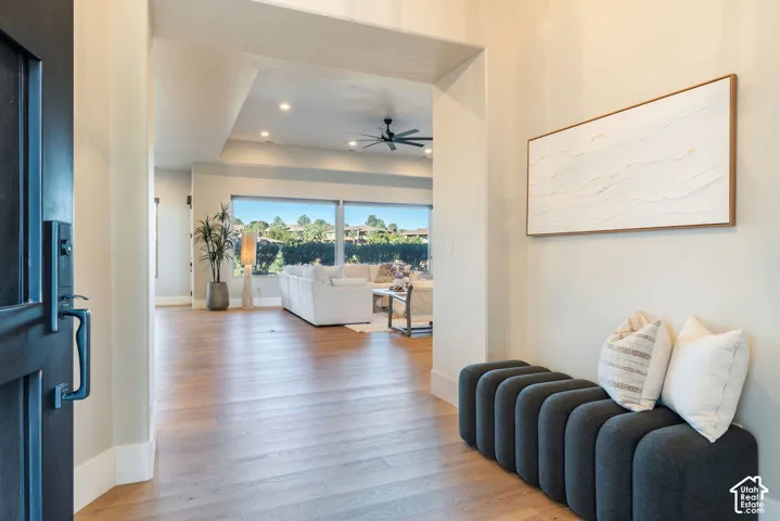 Foyer entry featuring wood-finish flooring, recessed lighting, and a tray ceiling