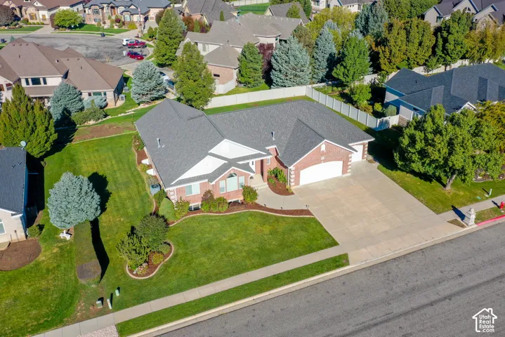 Single-level residence featuring a brick and siding exterior, multi-pitched shingle roof, attached two-car garage, concrete driveway, and landscaped front lawn