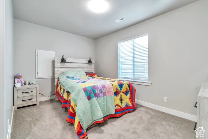Neutral-toned walls, plush wall-to-wall carpeting, window with integrated blinds, recessed ceiling lighting, and built-in wall access panel