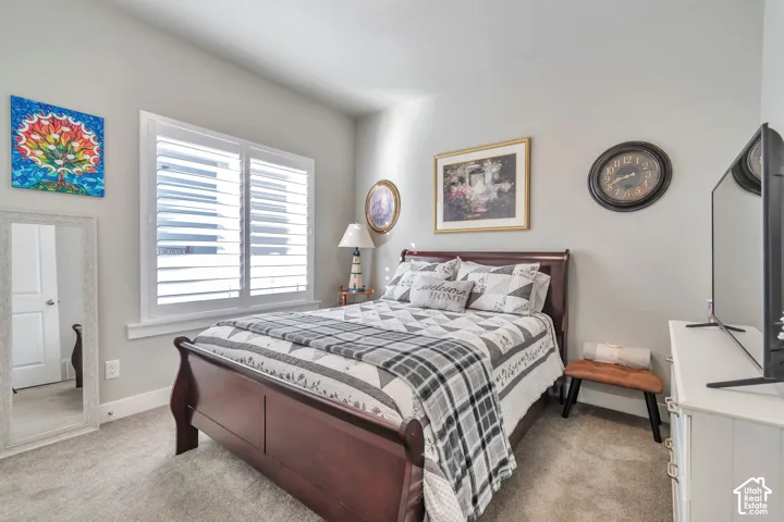 Room featuring neutral wall tones, interior plantation shutters, and wall-to-wall carpeting