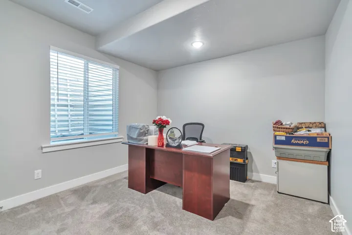Neutral interior room featuring neutral wall paint, carpeted flooring, and a single-pane window with installed blinds
