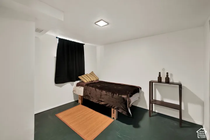 Neutral-toned walls, dark painted flooring, and a flush-mount square ceiling light fixture