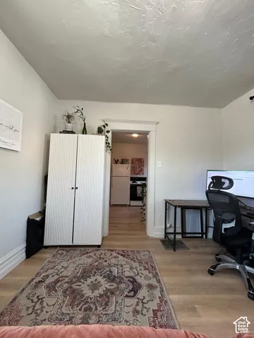 Light-toned wood-finish flooring and traditional door casing with a rectangular header