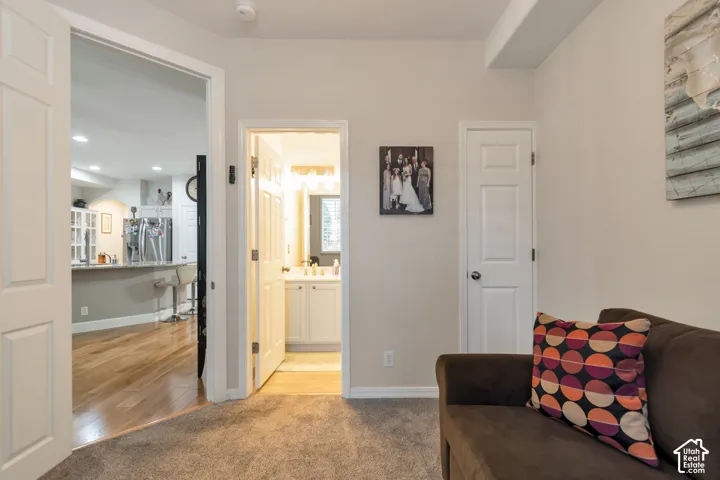 Interior area featuring neutral wall paint, carpeted flooring, and multiple six-panel interior doors