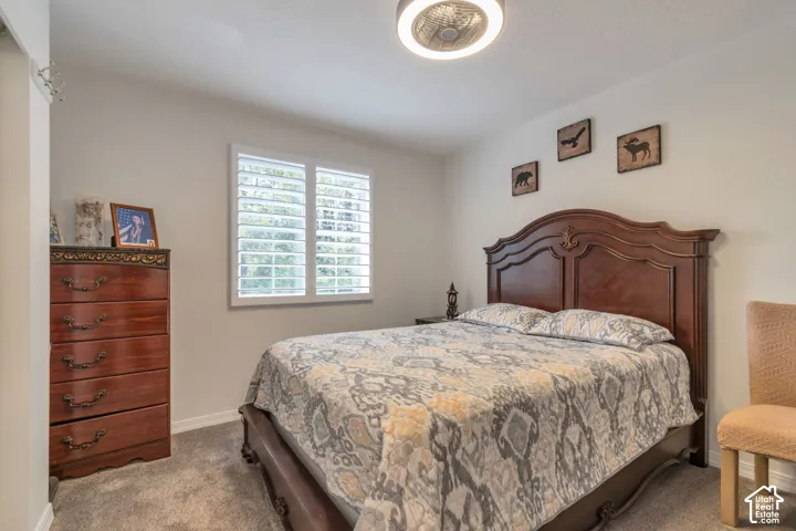 Neutral wall tones, plantation shutters, and a modern circular flush-mount ceiling fixture