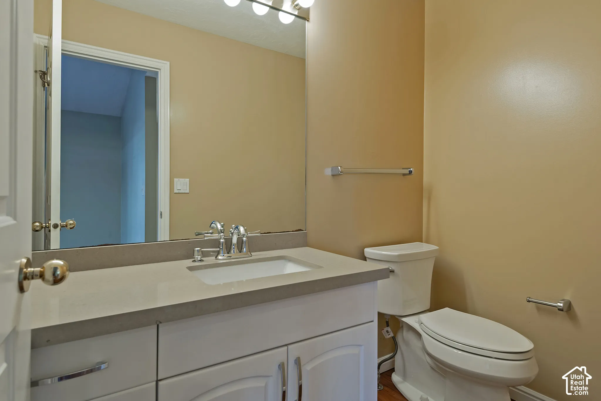 Bright bathroom featuring a vanity with dual-sink configuration and ample counter space, combined with tile flooring, recessed lighting, and polished chrome fixtures
