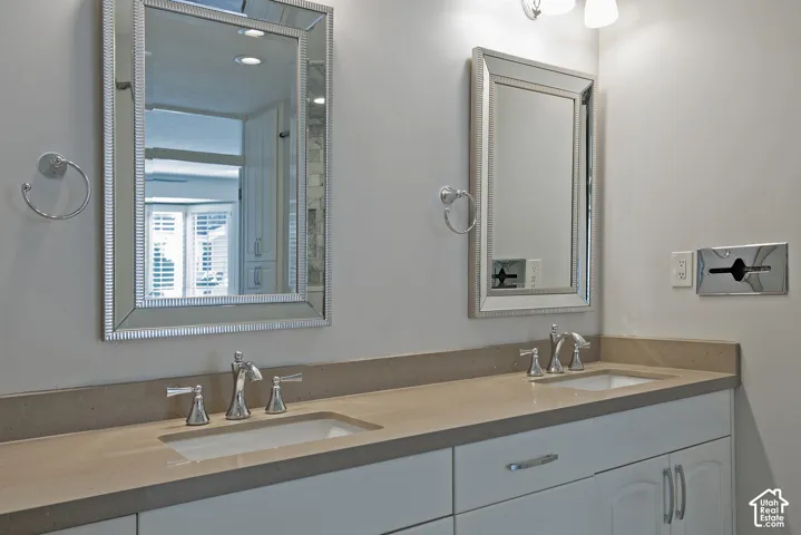 Dual vanity with integrated sinks, framed mirrors, and chrome fixtures