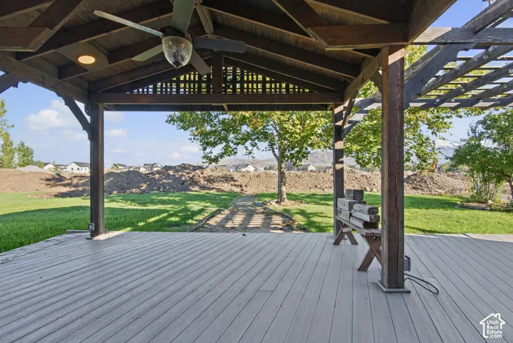 Covered outdoor patio featuring a wood-beam vaulted ceiling, integrated ceiling fan, recessed lighting, and an attached timber-frame pergola