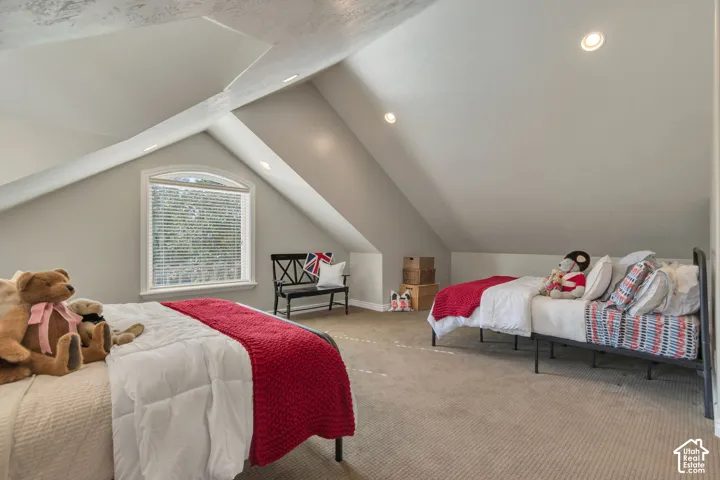 Vaulted ceilings with recessed lighting, architectural wall angles, and an arched window