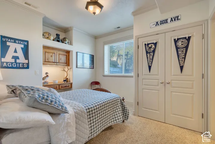 Built-in wooden cabinetry with integrated desk space, dual-panel closet doors, and recessed ceiling lighting