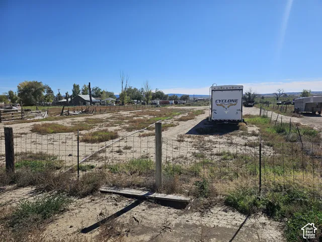 Expansive lot featuring perimeter wire fencing and open topography